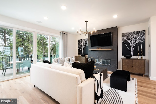 42152 Stone Press Ter, Brambleton, VA 20148 - living area with a chandelier, light wood finished floors, a fireplace, and recessed lighting