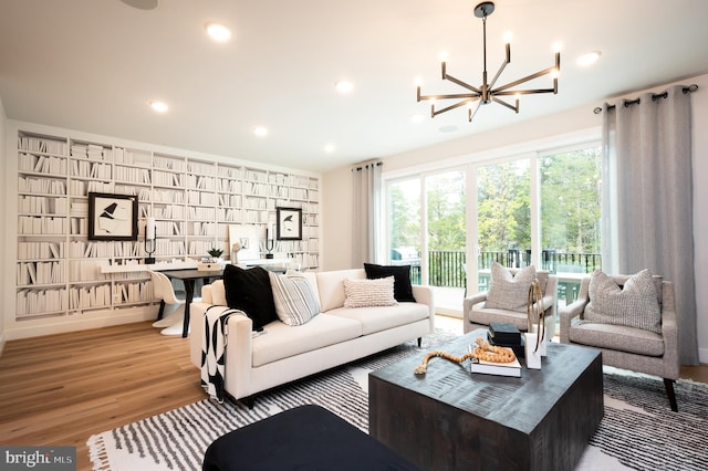 42152 Stone Press Ter, Brambleton, VA 20148 - living room with wood finished floors, a chandelier, and recessed lighting