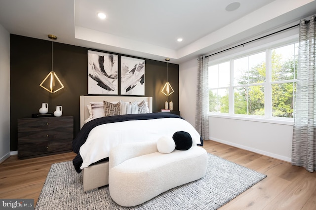 42152 Stone Press Ter, Brambleton, VA 20148 - bedroom with baseboards, wood finished floors, recessed lighting, and a tray ceiling