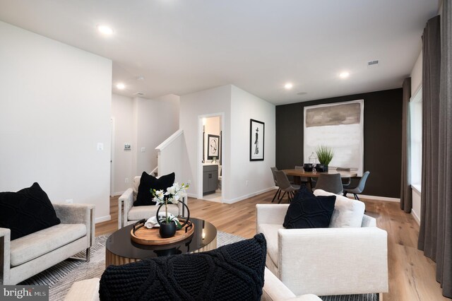 42152 Stone Press Ter, Brambleton, VA 20148 - living area with light wood finished floors, baseboards, and recessed lighting