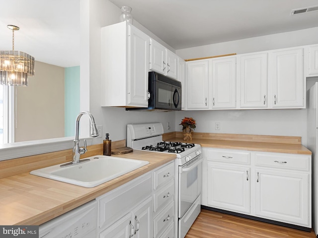 411 Stonebridge Blvd, New Castle, DE 19720 - kitchen with white appliances, a sink, a chandelier, white cabinetry, and light wood-type flooring