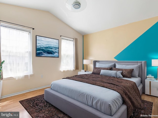 411 Stonebridge Blvd, New Castle, DE 19720 - bedroom with lofted ceiling, wood finished floors, and baseboards
