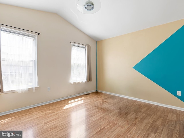 411 Stonebridge Blvd, New Castle, DE 19720 - empty room featuring lofted ceiling, wood finished floors, and baseboards
