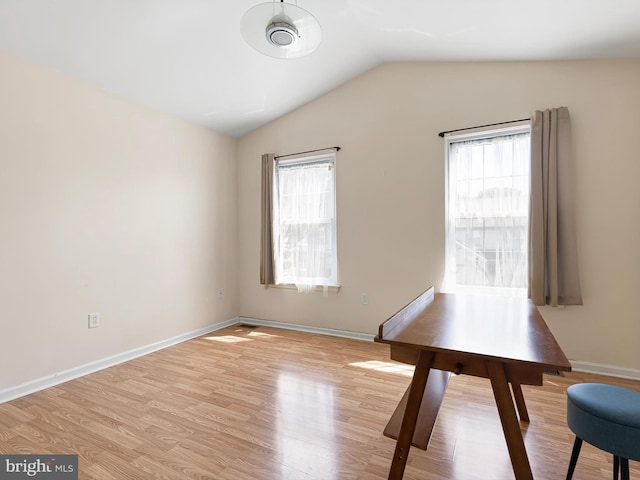 411 Stonebridge Blvd, New Castle, DE 19720 - unfurnished dining area featuring lofted ceiling, light wood-type flooring, and baseboards