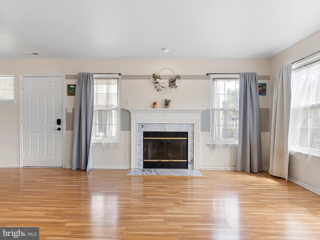 411 Stonebridge Blvd, New Castle, DE 19720 - unfurnished living room with wood finished floors, baseboards, and a premium fireplace