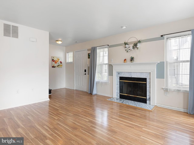 411 Stonebridge Blvd, New Castle, DE 19720 - unfurnished living room featuring light wood-style floors, baseboards, and a high end fireplace