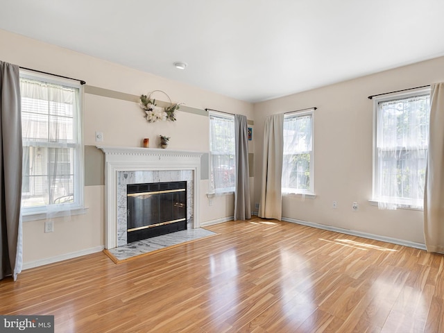 411 Stonebridge Blvd, New Castle, DE 19720 - unfurnished living room with wood finished floors, baseboards, and a premium fireplace