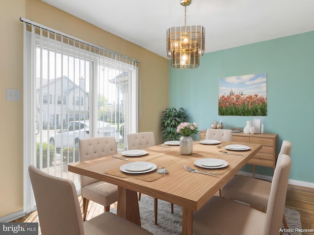 411 Stonebridge Blvd, New Castle, DE 19720 - dining area with a chandelier, wood finished floors, and baseboards