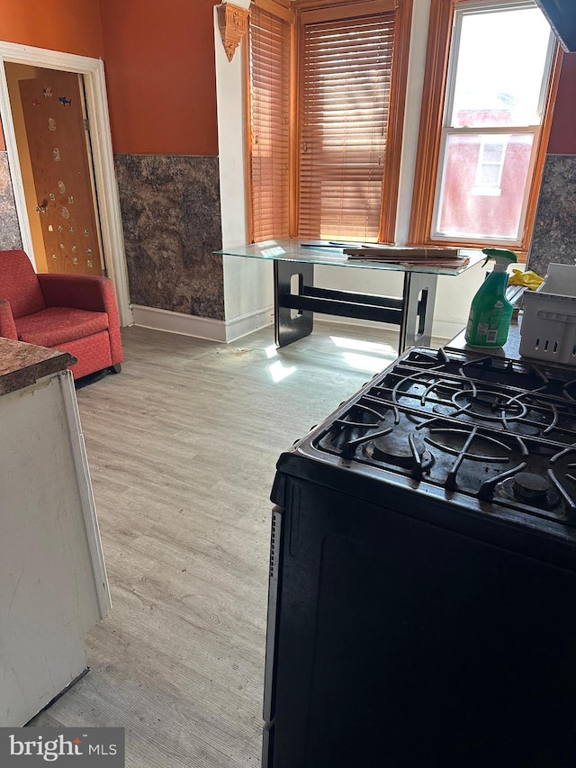641 N 56th St, Philadelphia, PA 19131 - kitchen featuring black range with gas stovetop, light wood-type flooring, and baseboards