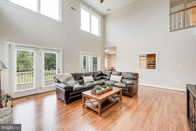 38452 Millstone, Purcellville, VA 20132 - living area featuring light wood-type flooring, a towering ceiling, plenty of natural light, and ceiling fan