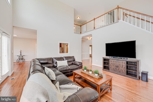38452 Millstone, Purcellville, VA 20132 - living room featuring a high ceiling, wood finished floors, baseboards, and stairway