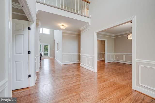 38452 Millstone, Purcellville, VA 20132 - foyer with light wood-type flooring, a decorative wall, crown molding, and wainscoting