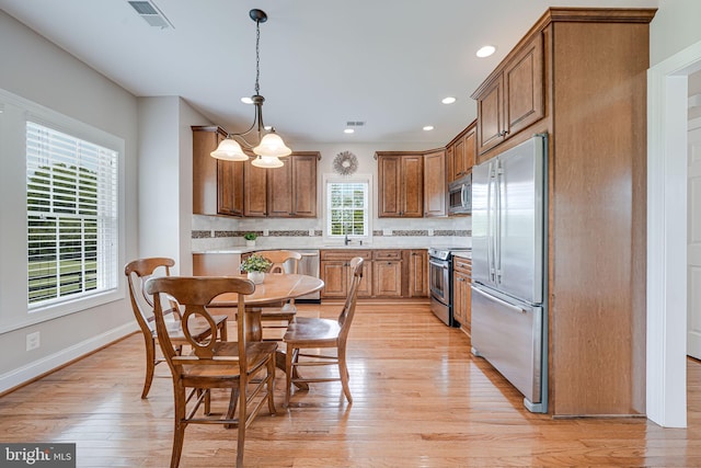 38452 Millstone, Purcellville, VA 20132 - kitchen with stainless steel appliances, brown cabinets, light countertops, recessed lighting, and decorative light fixtures