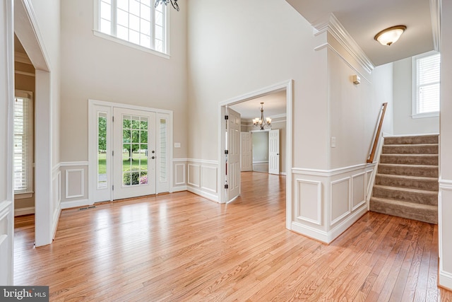 38452 Millstone, Purcellville, VA 20132 - entrance foyer featuring a chandelier, healthy amount of natural light, light wood-type flooring, a decorative wall, and a towering ceiling