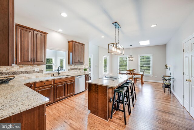 38452 Millstone, Purcellville, VA 20132 - kitchen with stainless steel dishwasher, a breakfast bar, a sink, a center island, and black electric stovetop
