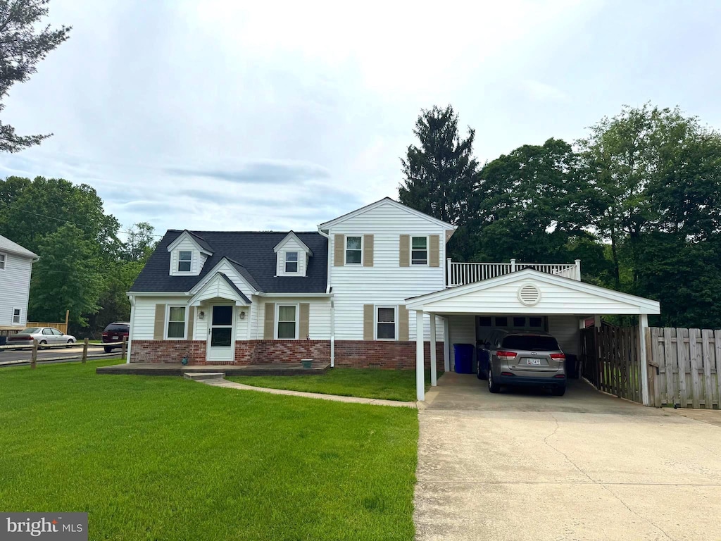 view of front of home with brick siding, concrete driveway, and a detached carport