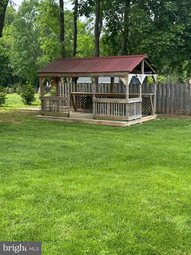 back of property with metal roof and view of wooded area