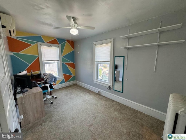 carpeted office space featuring radiator, plenty of natural light, a ceiling fan, and a wall unit AC