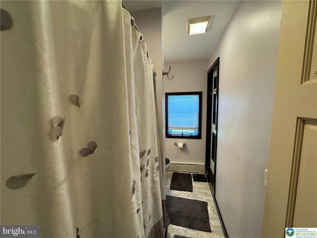 full bathroom featuring a shower with curtain and a baseboard radiator