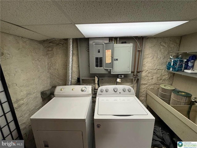 laundry area with washing machine and dryer and electric panel