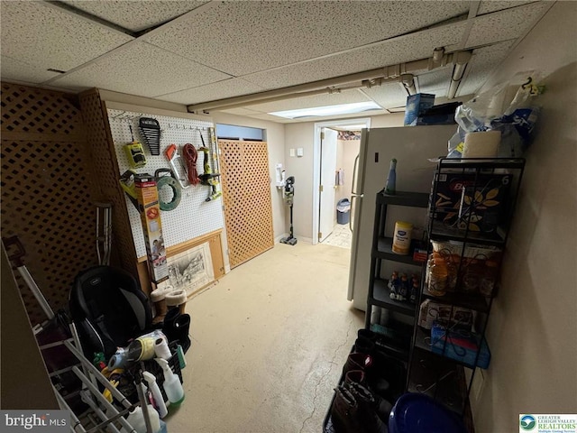 finished below grade area featuring a paneled ceiling