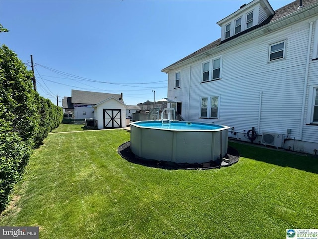 view of grassy yard with a storage shed, an outbuilding, and a cooling unit