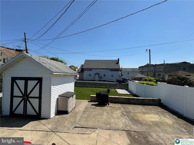 view of patio with a shed and an outdoor structure