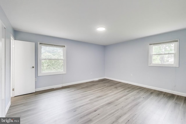unfurnished room featuring wood finished floors and baseboards