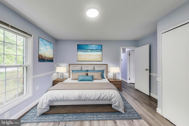 bedroom with baseboards and wood finished floors