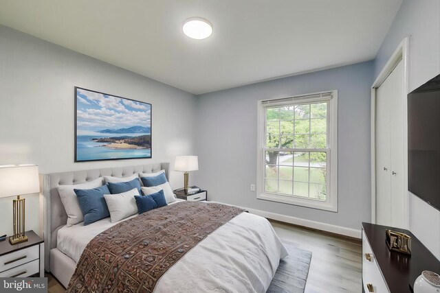 bedroom with wood finished floors and baseboards
