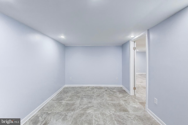 spare room featuring baseboards and recessed lighting
