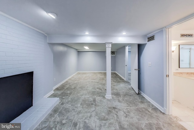 finished below grade area featuring a fireplace with raised hearth and baseboards