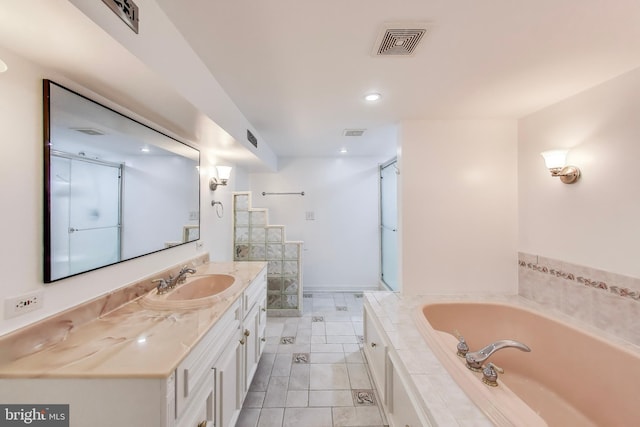 bathroom featuring vanity, a garden tub, and recessed lighting