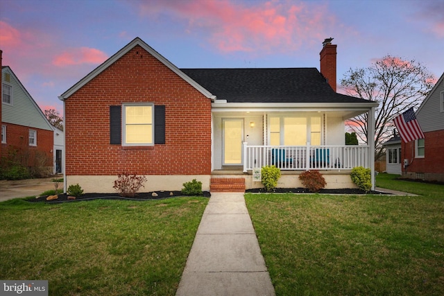 8907 Mavis Ave, Baltimore, MD 21236 - bungalow-style house featuring covered porch, brick siding, a chimney, and a front yard