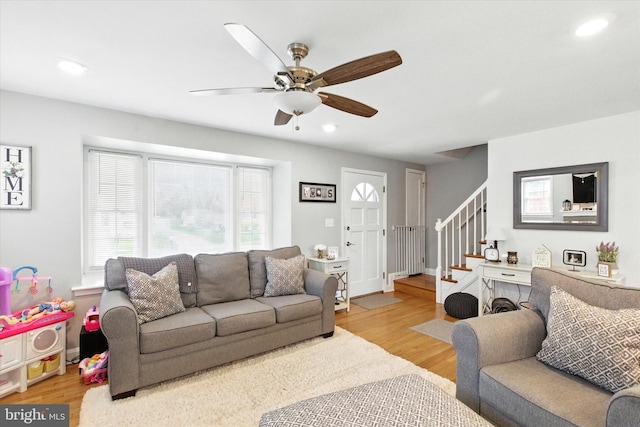 8907 Mavis Ave, Baltimore, MD 21236 - living room with light wood-type flooring, ceiling fan, stairs, and recessed lighting