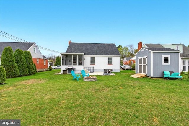 8907 Mavis Ave, Baltimore, MD 21236 - rear view of property featuring an outdoor fire pit, a sunroom, a shed, a chimney, and a lawn