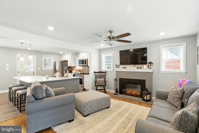 8907 Mavis Ave, Baltimore, MD 21236 - living area featuring healthy amount of natural light, light wood-style floors, and recessed lighting