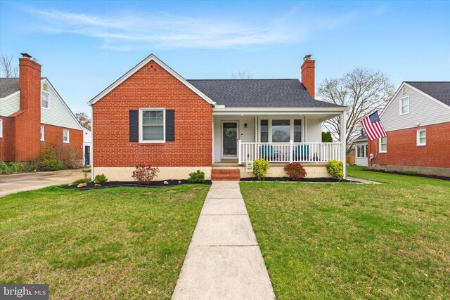 8907 Mavis Ave, Baltimore, MD 21236 - bungalow featuring covered porch, brick siding, a chimney, a front lawn, and a shingled roof