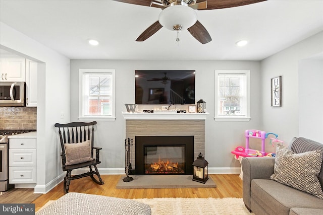 8907 Mavis Ave, Baltimore, MD 21236 - living area featuring healthy amount of natural light, a brick fireplace, ceiling fan, light wood-style floors, and recessed lighting
