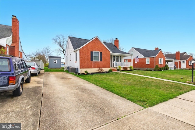 8907 Mavis Ave, Baltimore, MD 21236 - bungalow featuring brick siding, a front lawn, concrete driveway, central AC unit, and covered porch