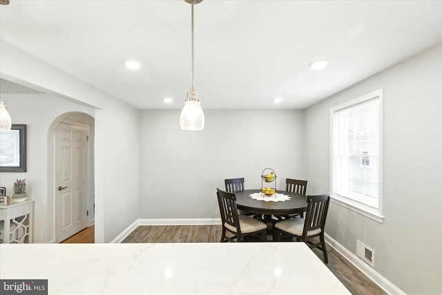 8907 Mavis Ave, Baltimore, MD 21236 - dining area featuring wood finished floors, baseboards, recessed lighting, and arched walkways