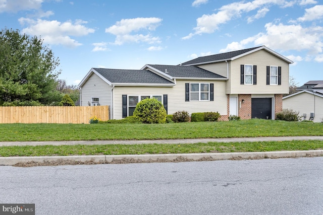 8838 Mckinley Ct, Hummelstown, PA 17036 - split level home featuring a garage, brick siding, and roof with shingles