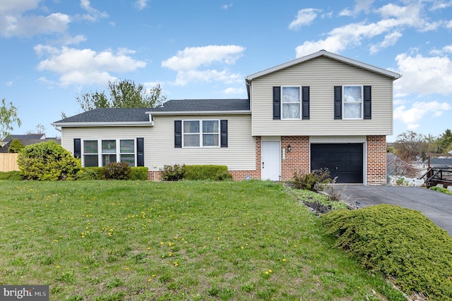 8838 Mckinley Ct, Hummelstown, PA 17036 - tri-level home featuring asphalt driveway, an attached garage, brick siding, and a front lawn