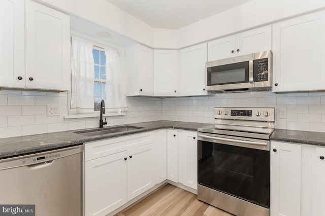 8838 Mckinley Ct, Hummelstown, PA 17036 - kitchen with appliances with stainless steel finishes, a sink, white cabinets, and light wood-type flooring