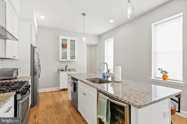 419 S E Ave, Baltimore, MD 21224 - kitchen with wine cooler, a sink, appliances with stainless steel finishes, baseboards, and an island with sink