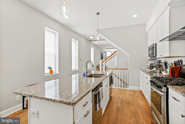419 S E Ave, Baltimore, MD 21224 - kitchen featuring a sink, stainless steel appliances, baseboards, wall chimney range hood, and recessed lighting