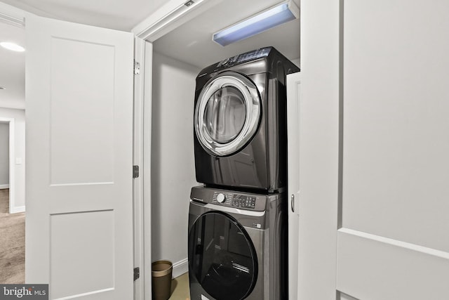 419 S E Ave, Baltimore, MD 21224 - laundry room with stacked washer / drying machine, baseboards, and carpet floors