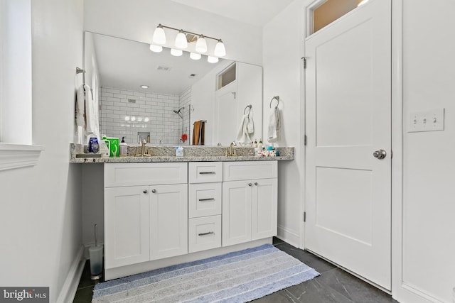 419 S E Ave, Baltimore, MD 21224 - bathroom with double vanity, tiled shower, marble finish floors, and baseboards