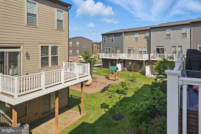 9870 Buchanan Loop, Manassas, VA 20110 - view of grassy yard featuring a deck, a residential view, and a patio area