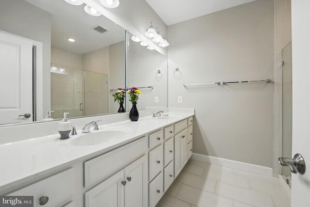 9870 Buchanan Loop, Manassas, VA 20110 - bathroom with double vanity, tiled shower, baseboards, and tile patterned flooring